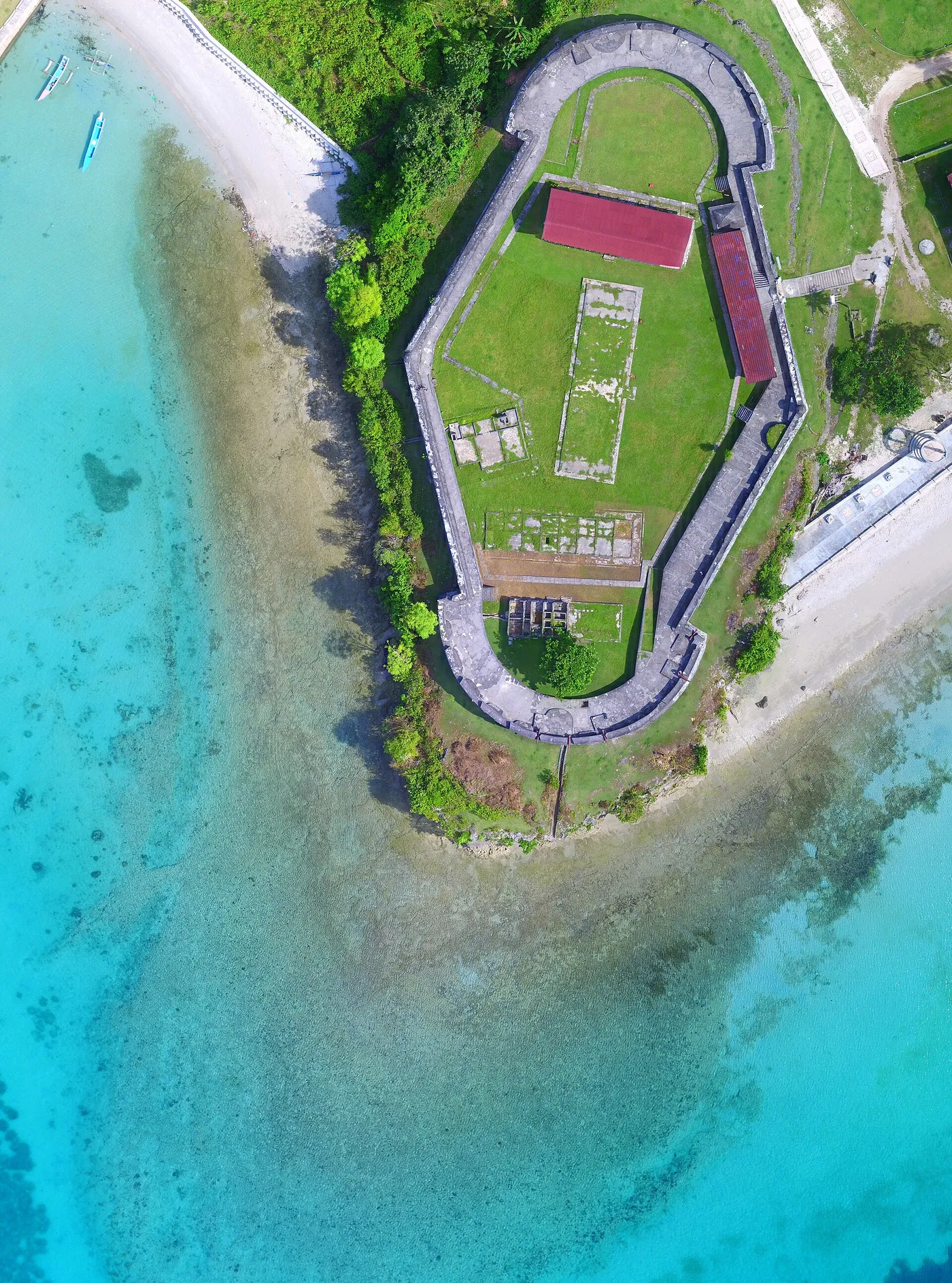 Aerial view of Fort Duurstede beside turquoise coastal water on Saparua Island, shown as regional context for Nusalaut